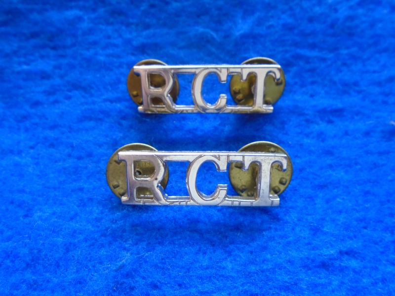 A PAIR OF NEW ROYAL CORPS OF TRANSPORT ANODISED STAYBRITE GOLD SHOULDER TITLES WITH CLUTCH PIN FIXINGS